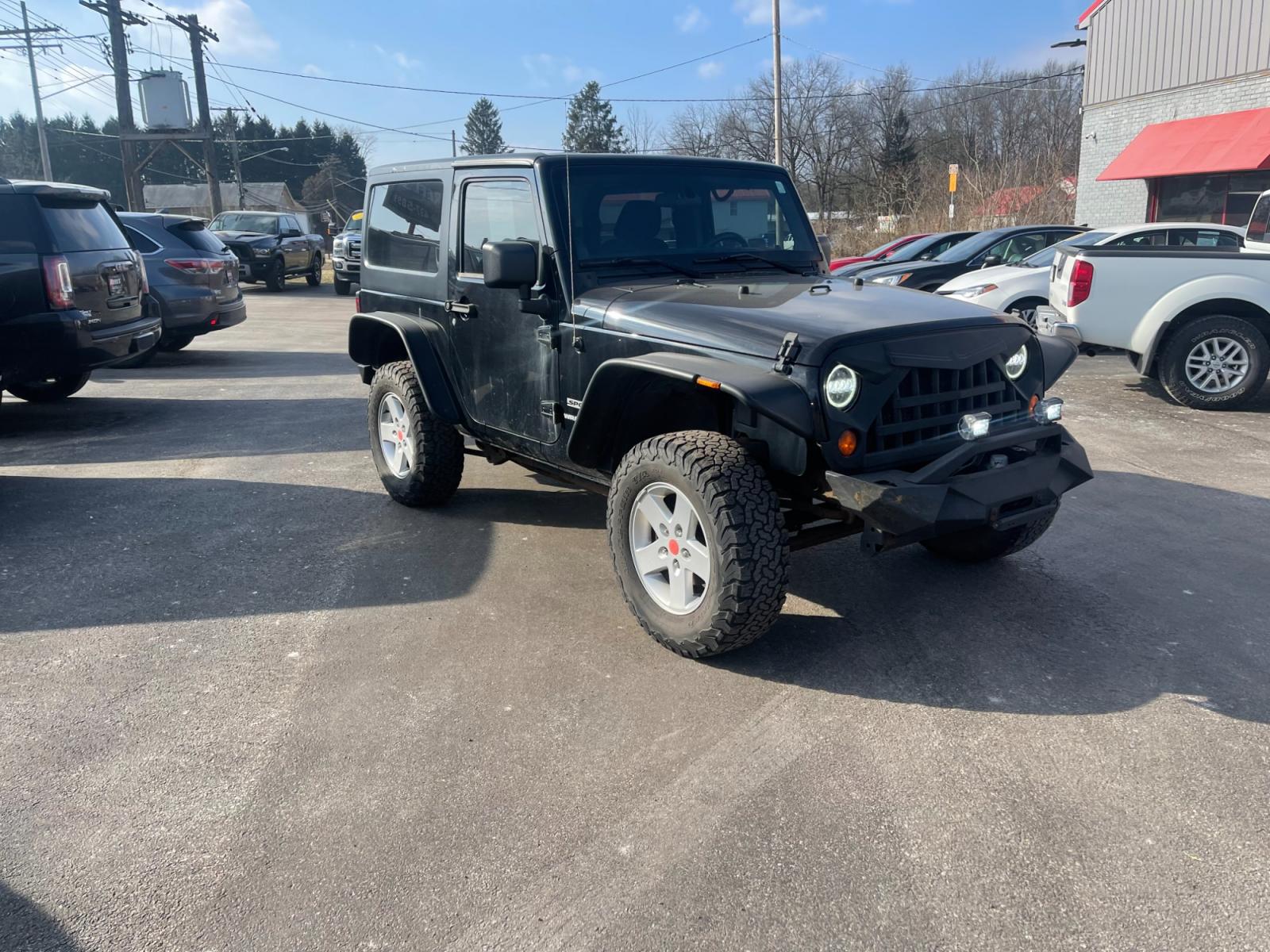 2013 Black /Black Jeep Wrangler Sport 4WD (1C4AJWAG0DL) with an 3.6L V6 DOHC 24V FFV engine, 6 Speed Manual transmission, located at 547 E. Main St., Orwell, OH, 44076, (440) 437-5893, 41.535435, -80.847855 - This 2013 Jeep Wrangler Sport 4WD, equipped with a robust 3.6L Pentastar V6 engine and a 6-speed manual transmission, represents a premium blend of performance and rugged capability. Its Trail Rated designation underscores a commitment to off-road excellence, featuring modifications such as LED head - Photo #2